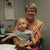 Pam Pullan in the office holding her grandson, sharing a special moment.