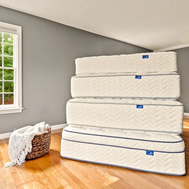  Stack of various DLX mattresses showcasing different hybrids offered by the brand.
