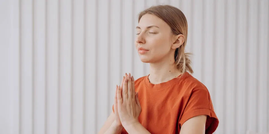 Women mediating while standing representing sleeping and standing.