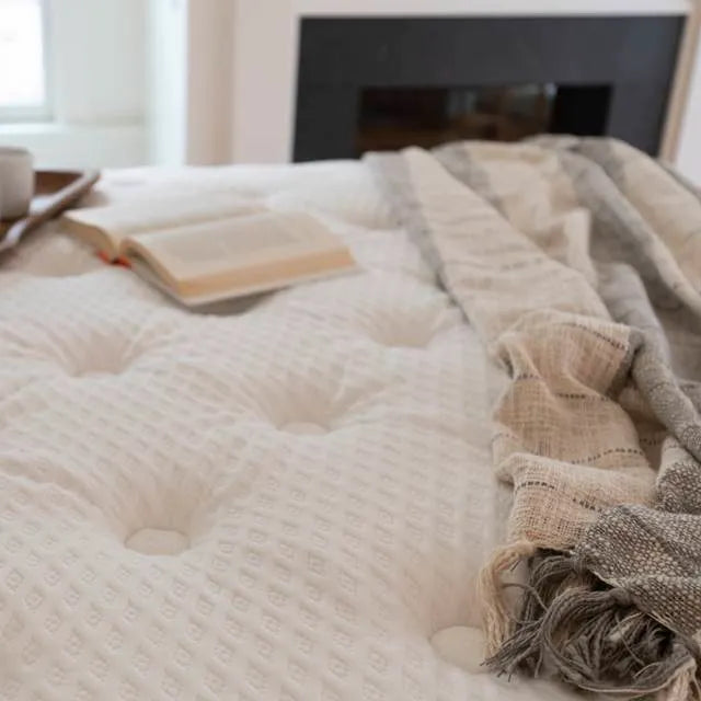 DLX mattress set in a beautiful bedroom. Each purchase ensures a blanket donation, showcasing DLX's commitment to giving back.