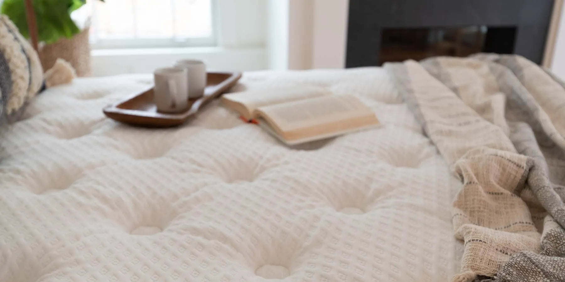 Mattress with a book and coffee mugs on a tray - Contact us for details.