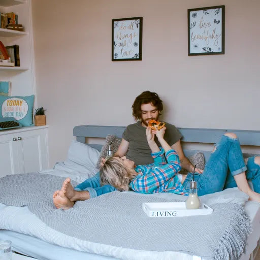 A contented couple lying on a DLX Mattress, epitomizing relaxation and comfort.