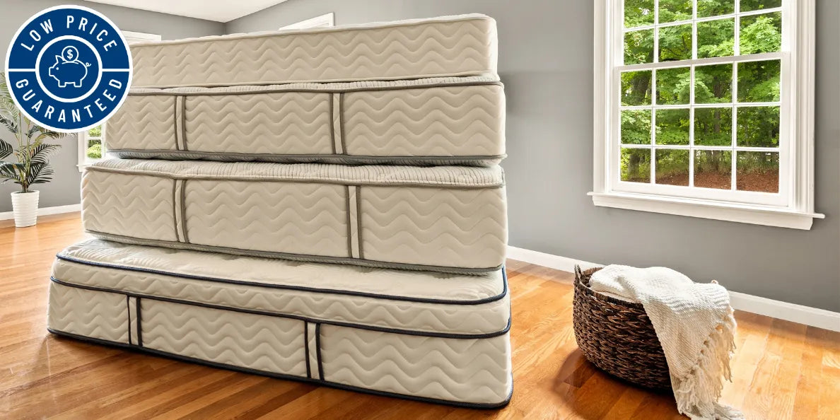 Stack of DLX hybrid mattresses with a 'Low Price Guaranteed' piggybank badge. A testament to the commitment of American quality and craftsmanship.