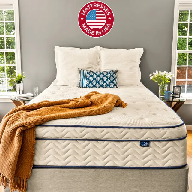 DLX Mattress set in a cozy bedroom, proudly displaying a "Made in the USA" logo.