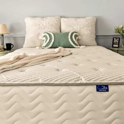  DLX mattress perfectly set on a bed frame, complemented by decorative pillows.