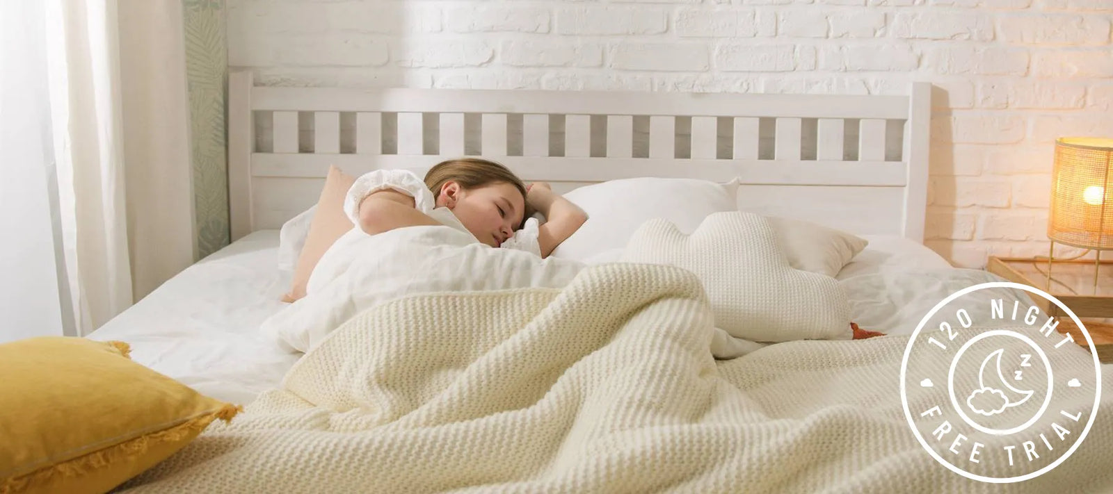 Girl sleeping in a peaceful room with DLX mattress 120-night trial badge