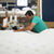 Craftsman flanging a quilted mattress cover, showcasing DLX's attention to detail.