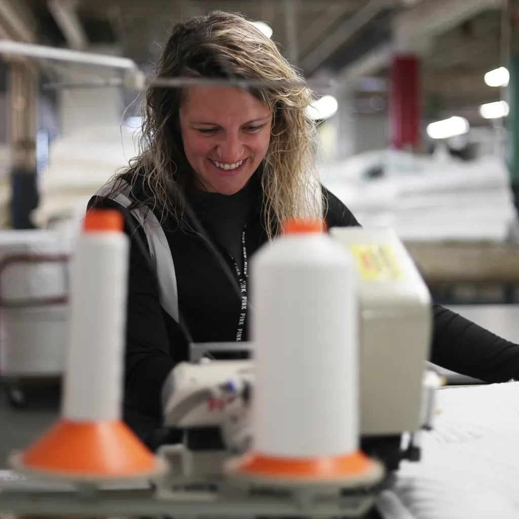 Skilled artisan in New York sewing a DLX mattress cover. Representing precision, durability, and comfort.