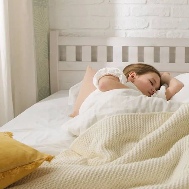 Girl experiencing peaceful sleep on a DLX mattress with comfort in purchase