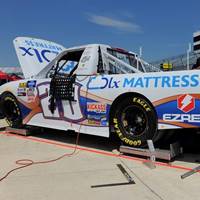 Spencer Boyd's NASCAR vehicle, prominently featuring the DLX mattress branding.
