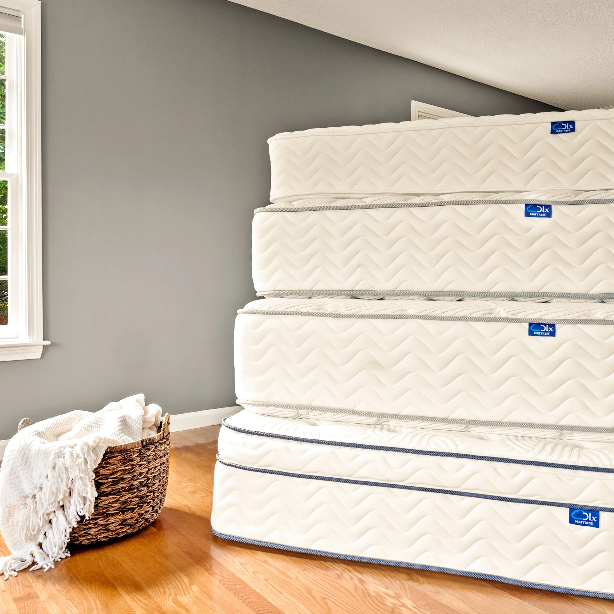 Stack of DLX mattresses representing commitment to quality and lifetime assurance