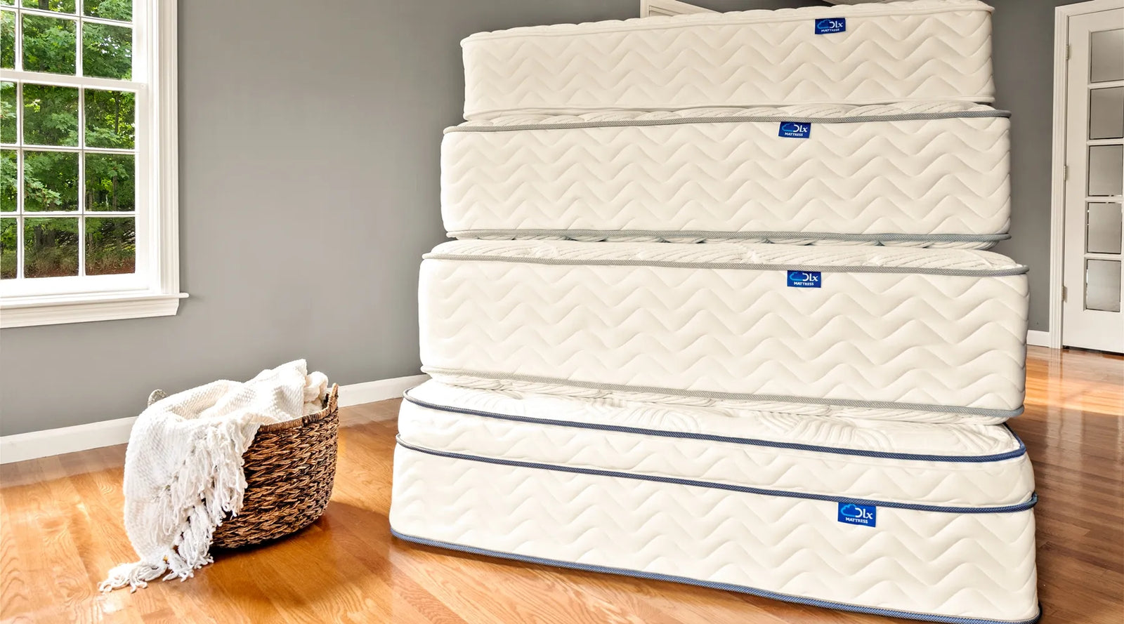 Stack of DLX mattresses representing commitment to quality and lifetime assurance