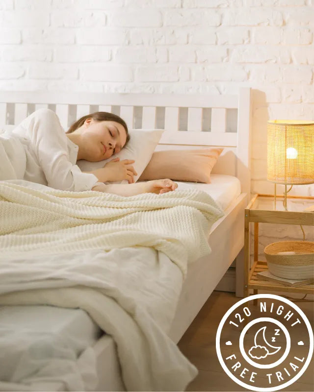 Woman resting in a serene room with DLX mattress 120-night trial badge